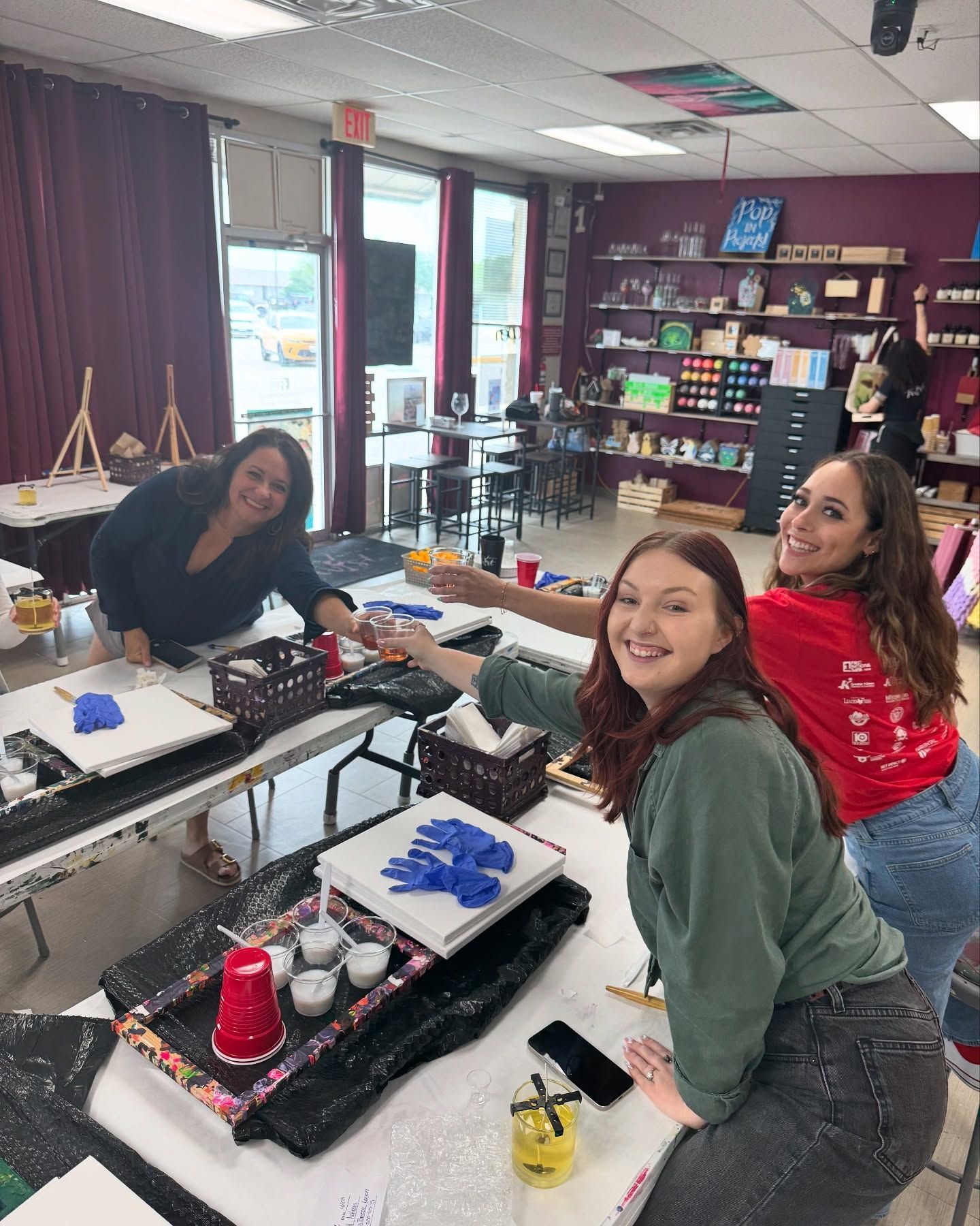 Three women are sitting at a table in a room.