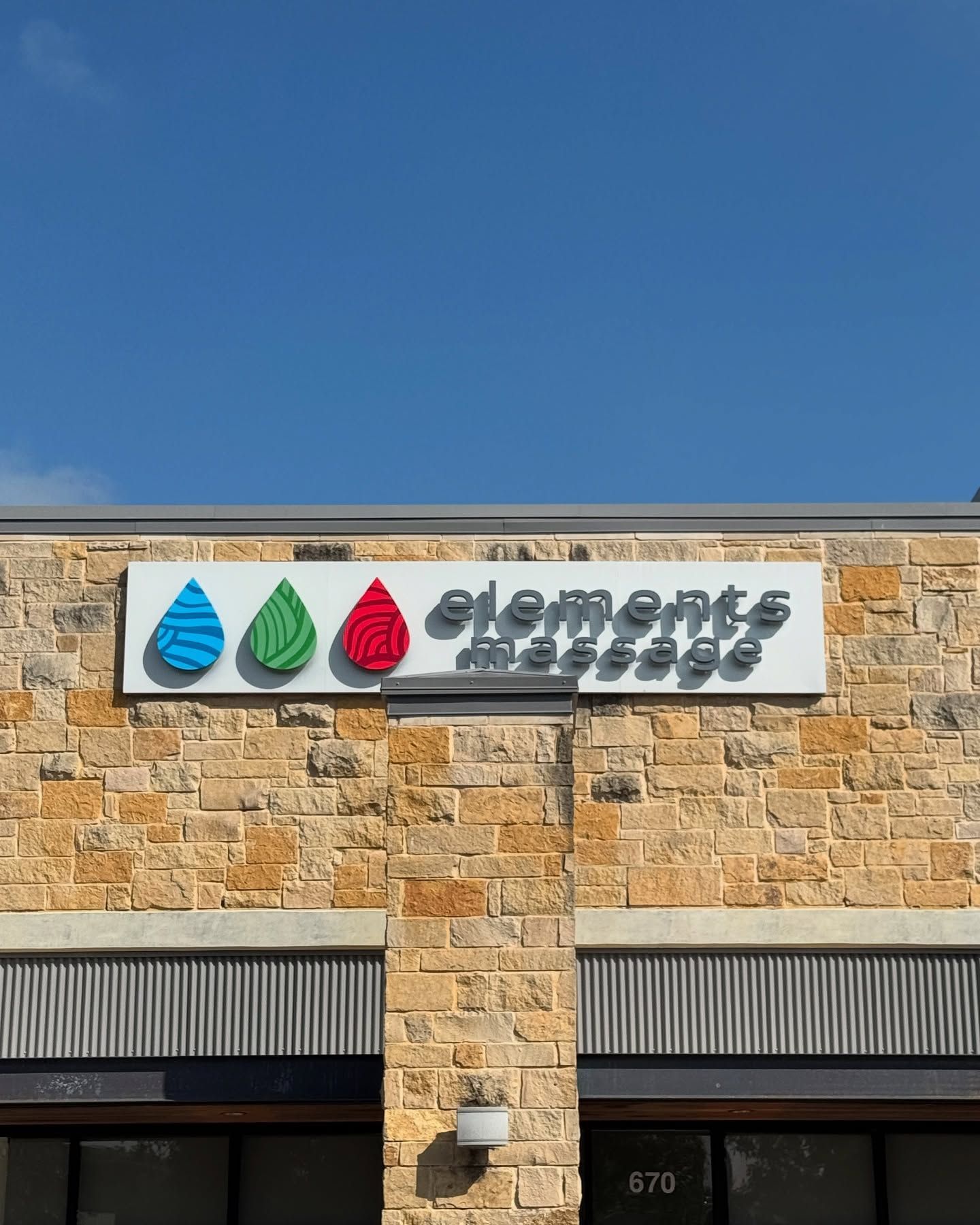The front of a building with a sign on it that says `` elements massage ''.