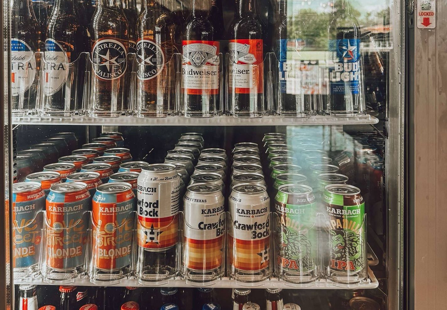 A refrigerator filled with lots of cans and bottles of beer.