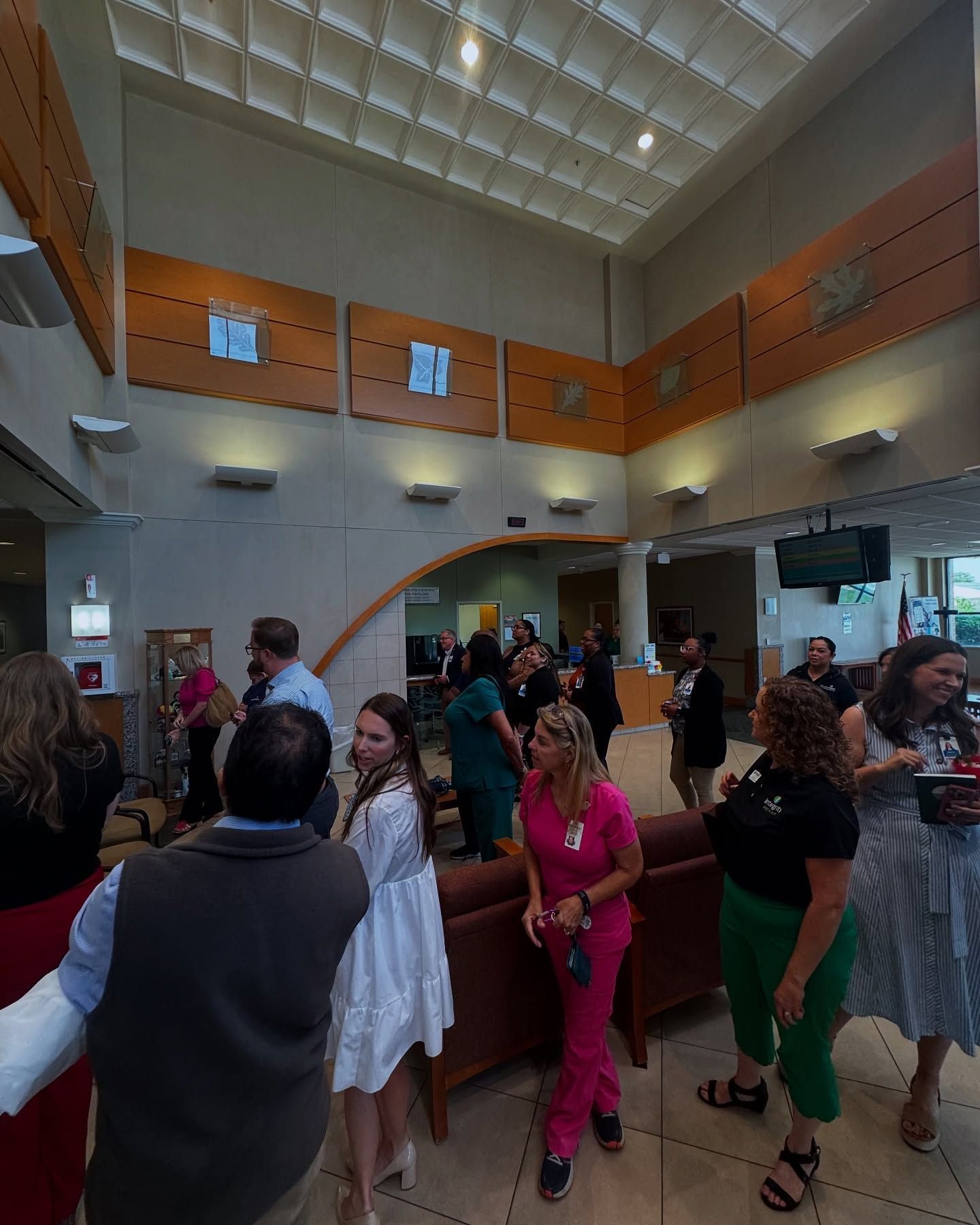 A group of people are gathered in a large room