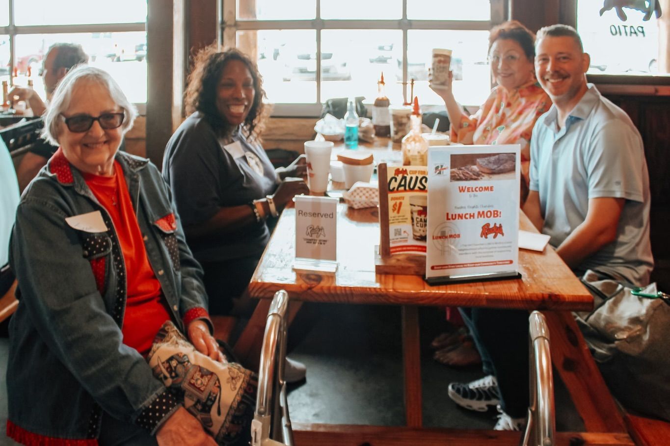 A group of people are sitting at a table in a restaurant.