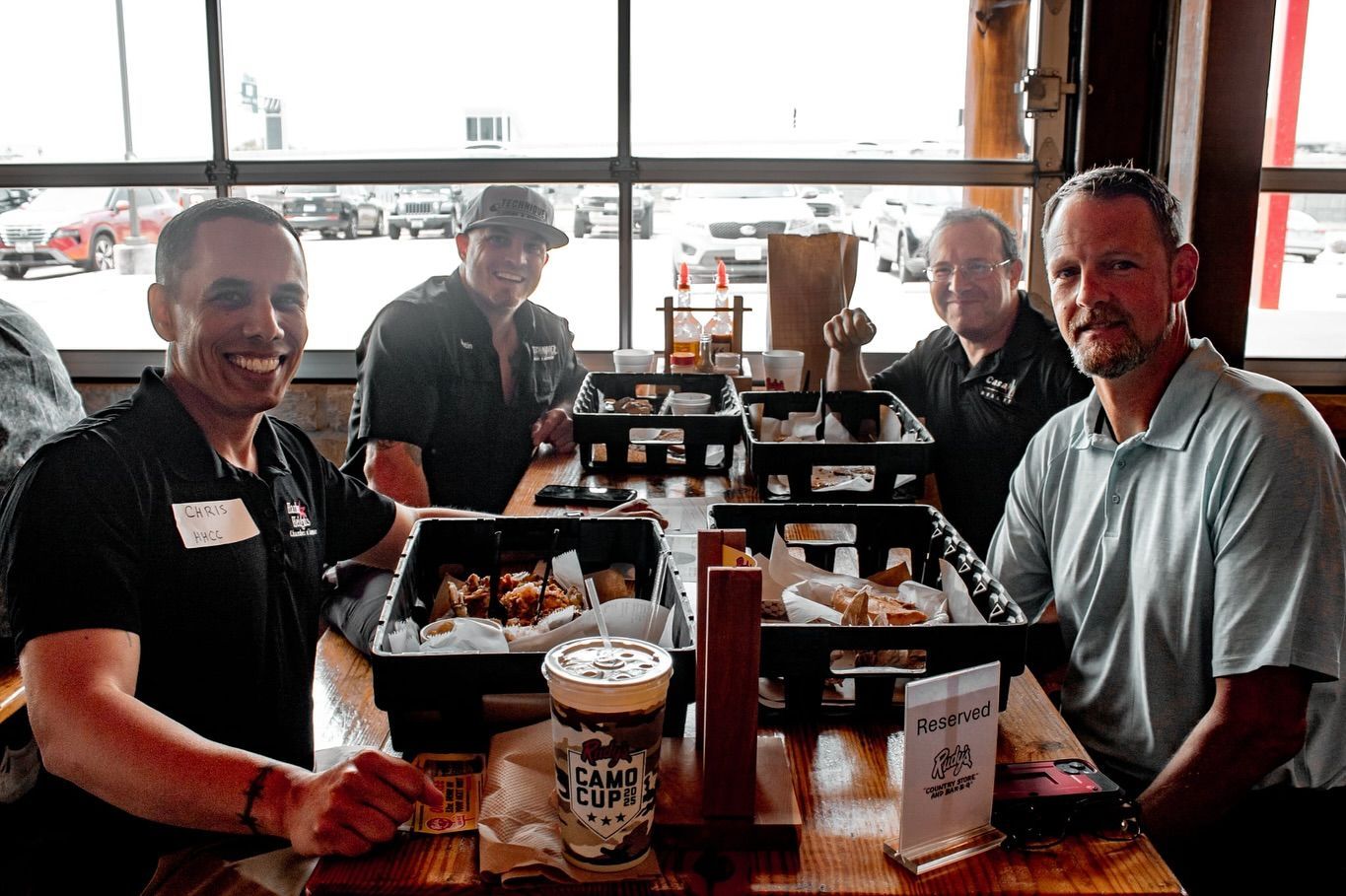 A group of people are sitting at a table in a restaurant eating food.