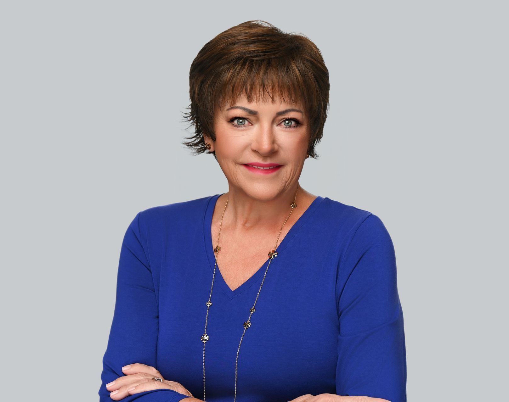 A close up of a woman 's face wearing a black shirt and smiling.
