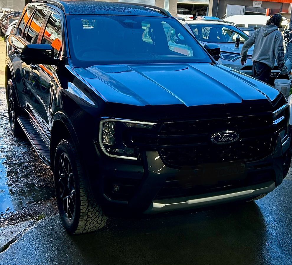 A black ford suv is parked in a parking lot