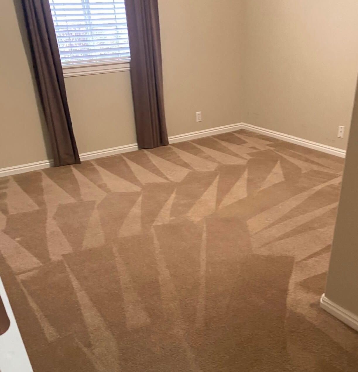 A room with a carpeted floor and a window