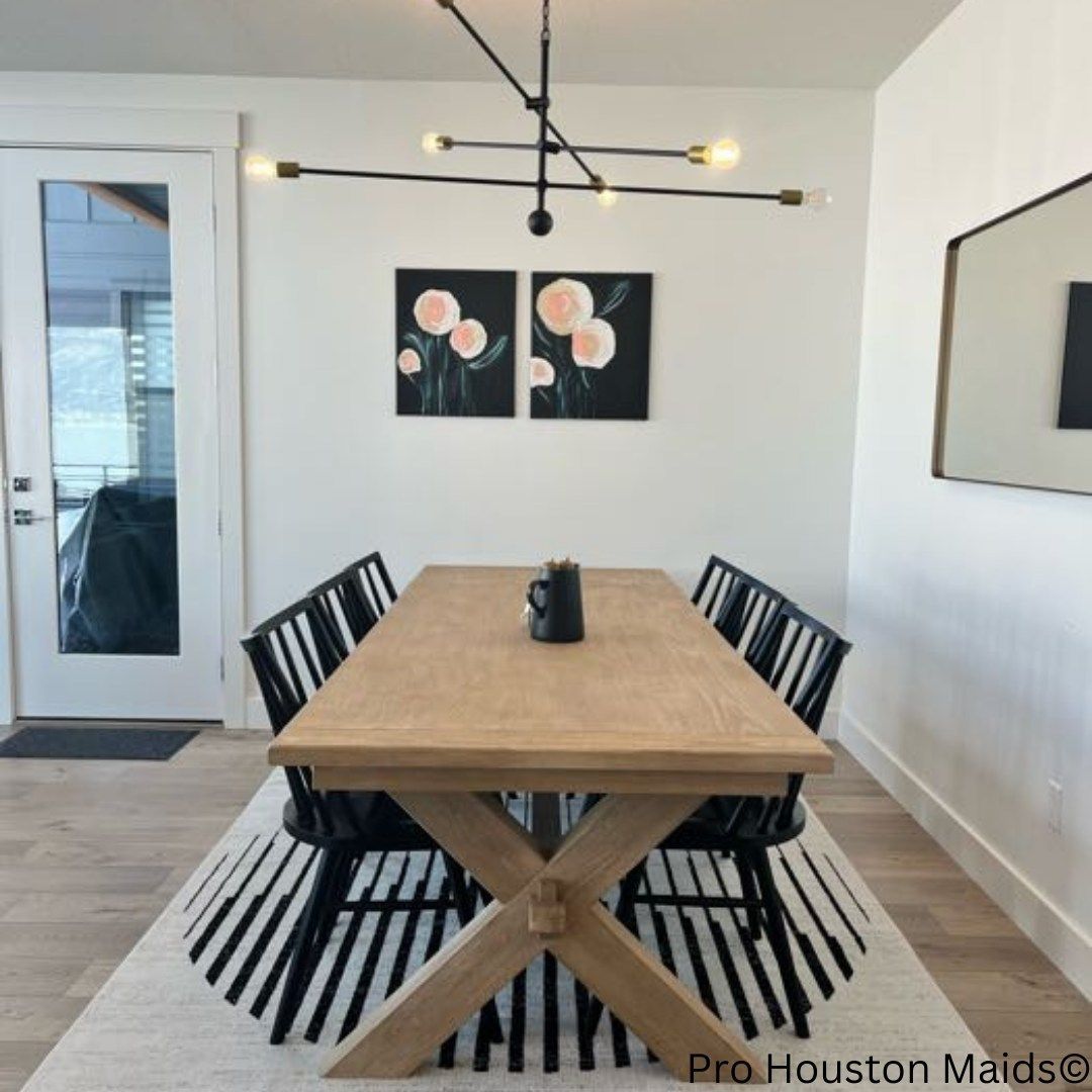 A dining room with a wooden table and black chairs