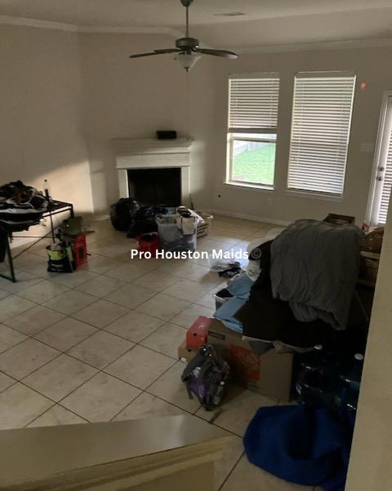 A living room filled with lots of junk and a fireplace.