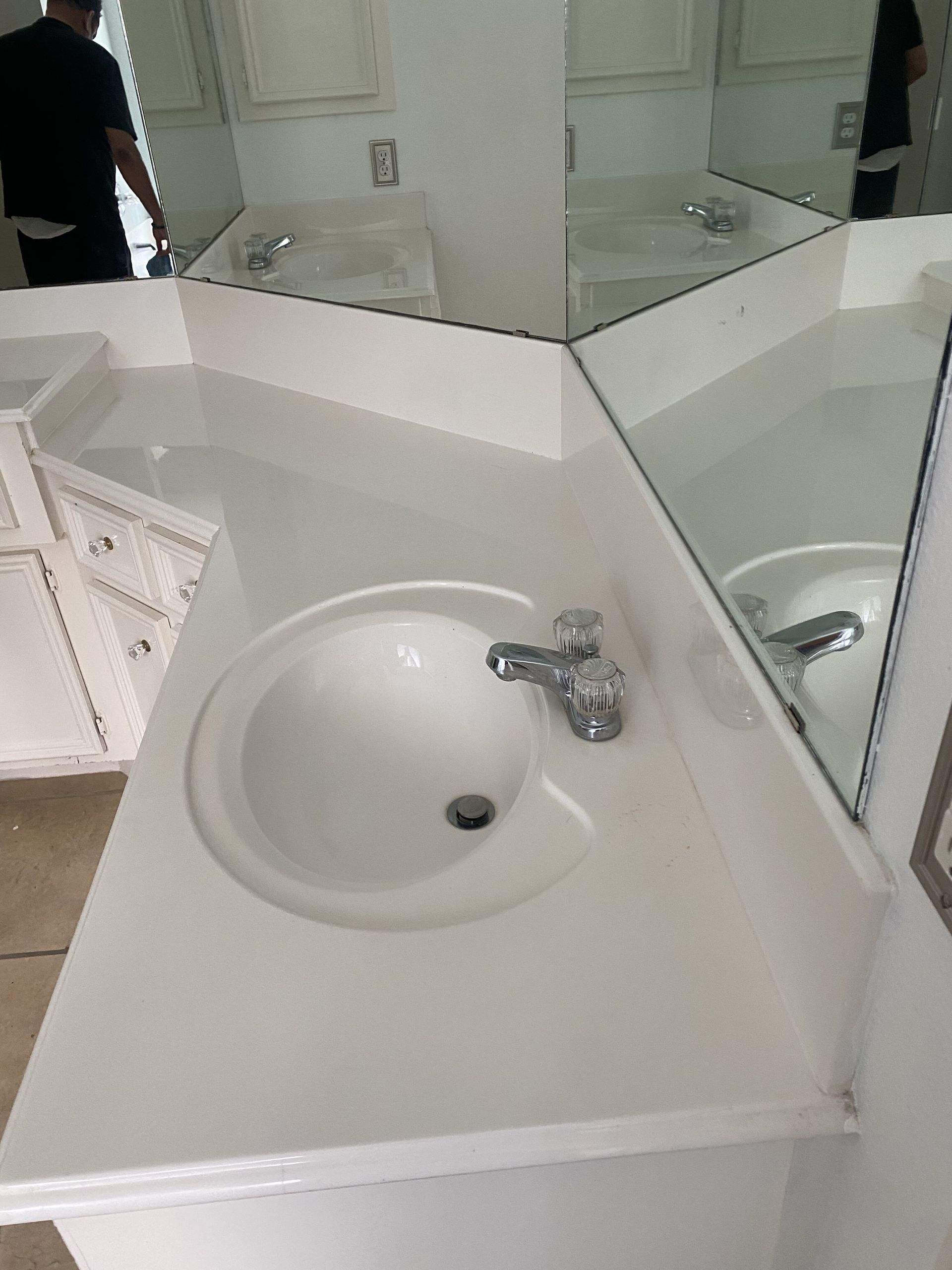 A bathroom counter with a sink and a mirror