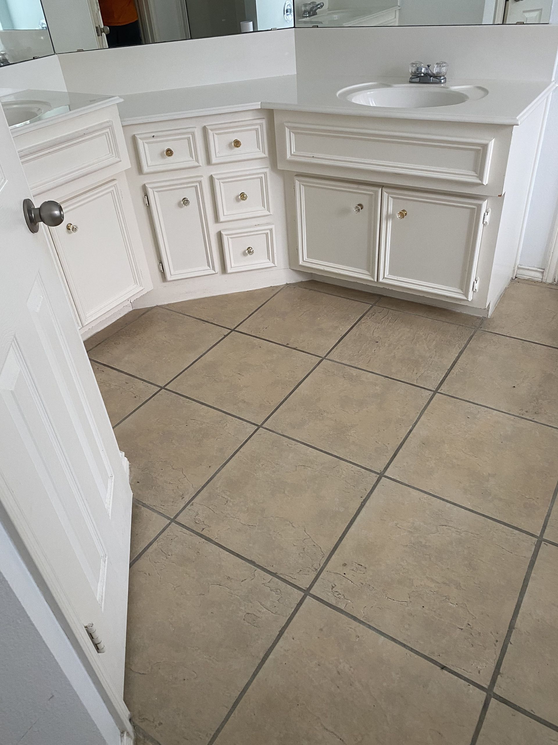 A bathroom with a sink and a tiled floor