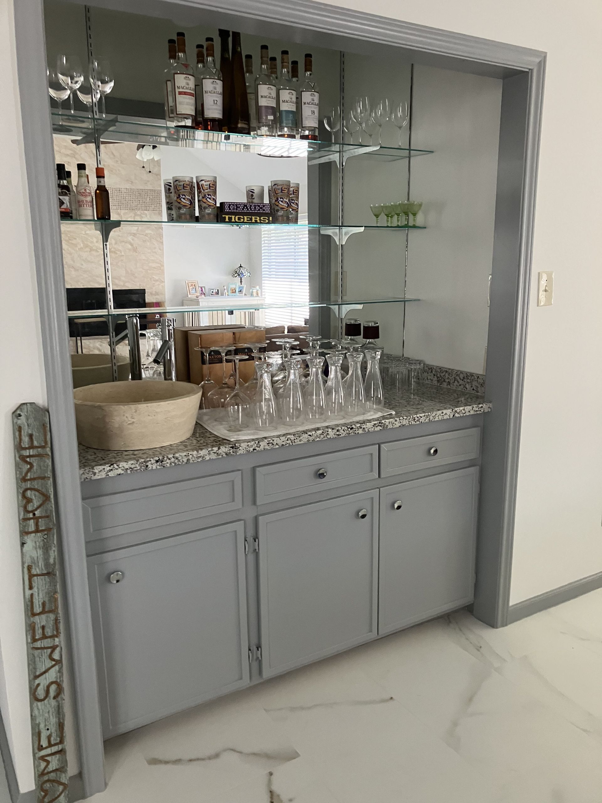 A bathroom with a sink and a sign that says `` the sweet home ''.