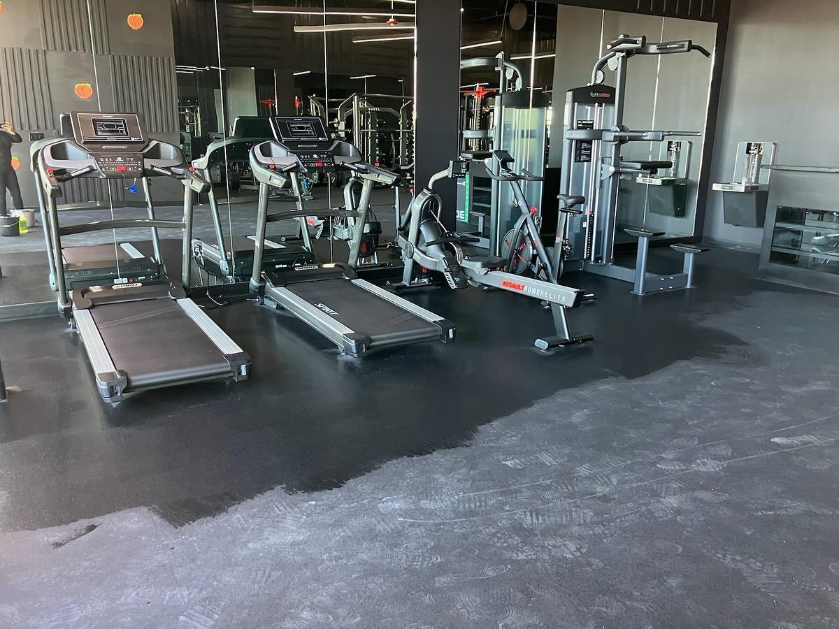 A gym with treadmills , a bicycle , and other exercise equipment