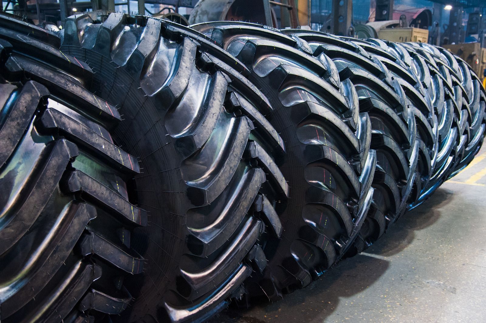 Tow truck carrying a silver station wagon on a highway.