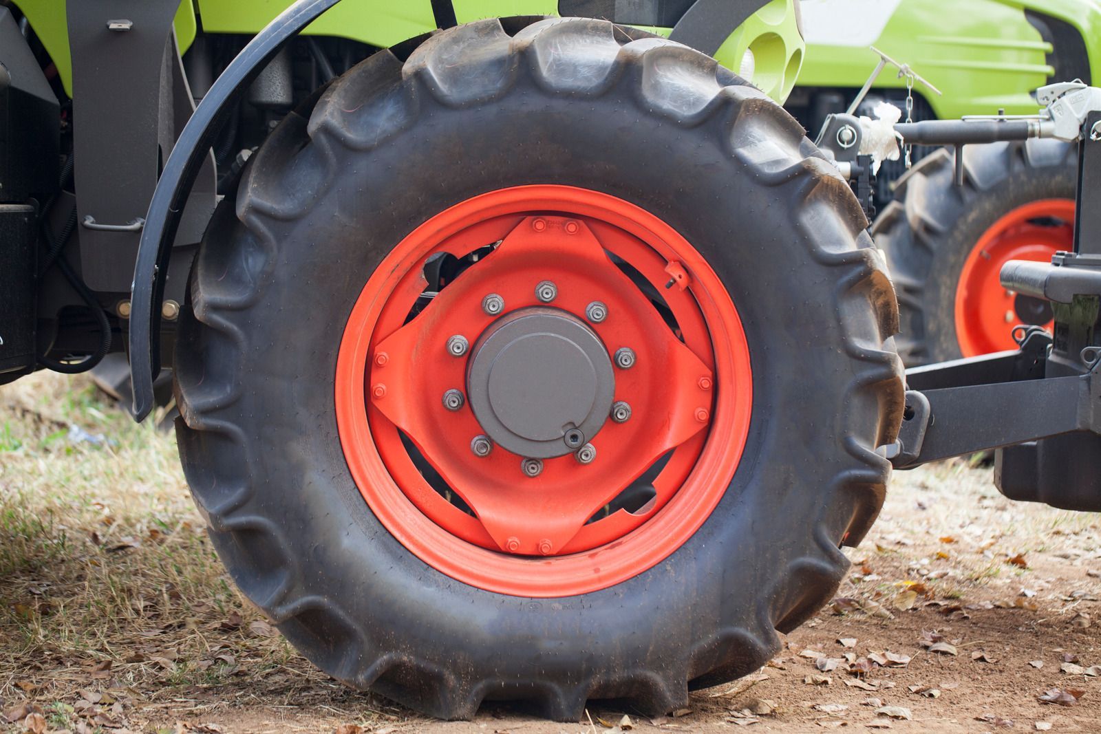 Tow truck carrying a silver station wagon on a highway.