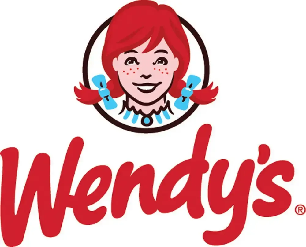 Wendy's logo featuring a smiling girl with red pigtails in a circular frame above the Wendy's wordmark.