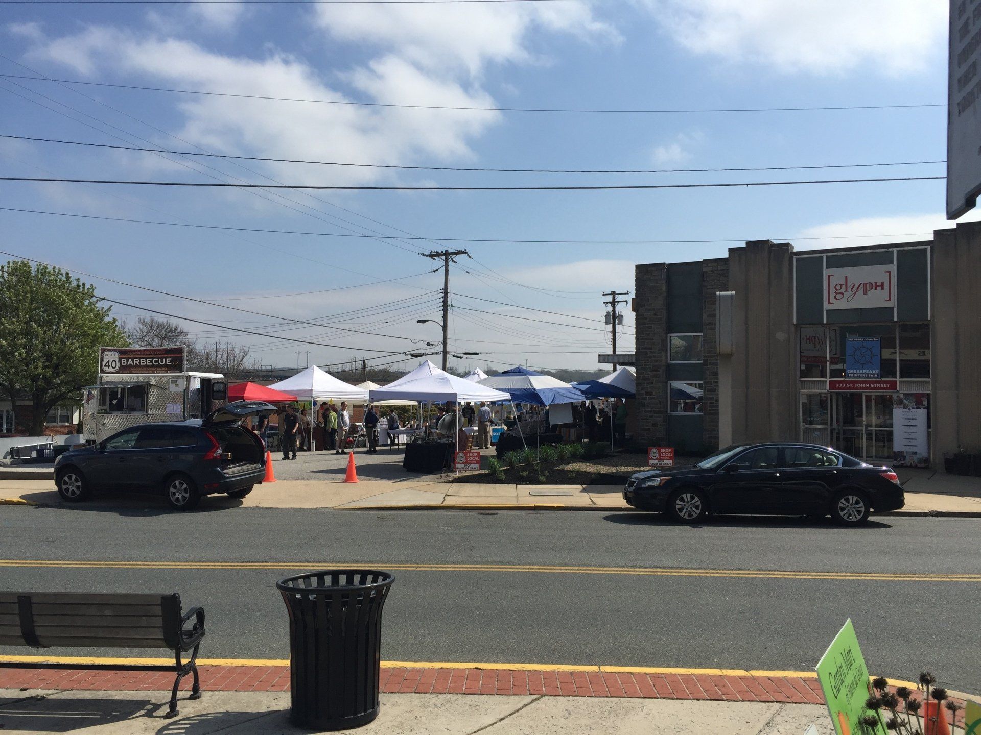 A black car is parked on the side of the road