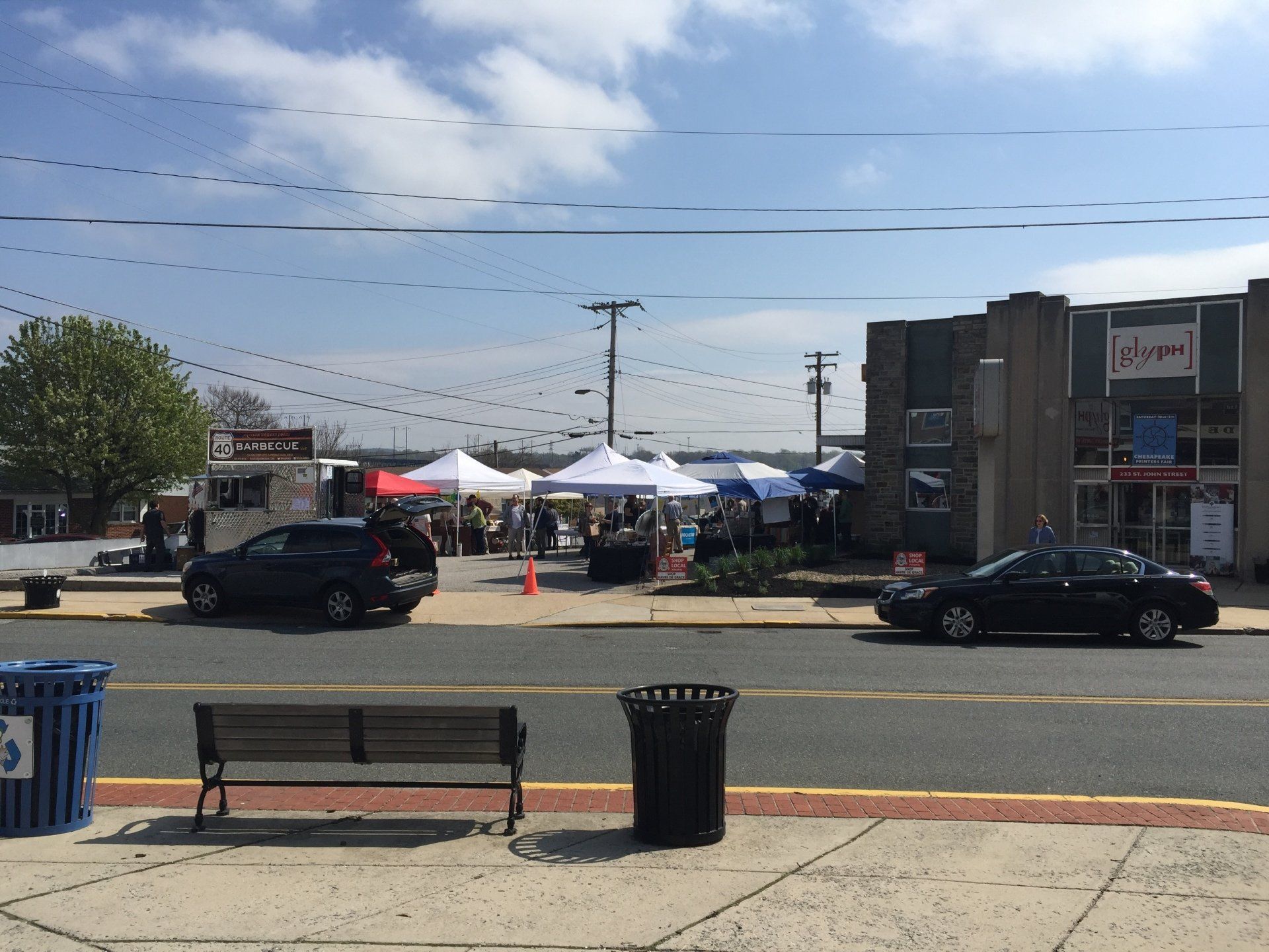 A black car is parked on the side of the road