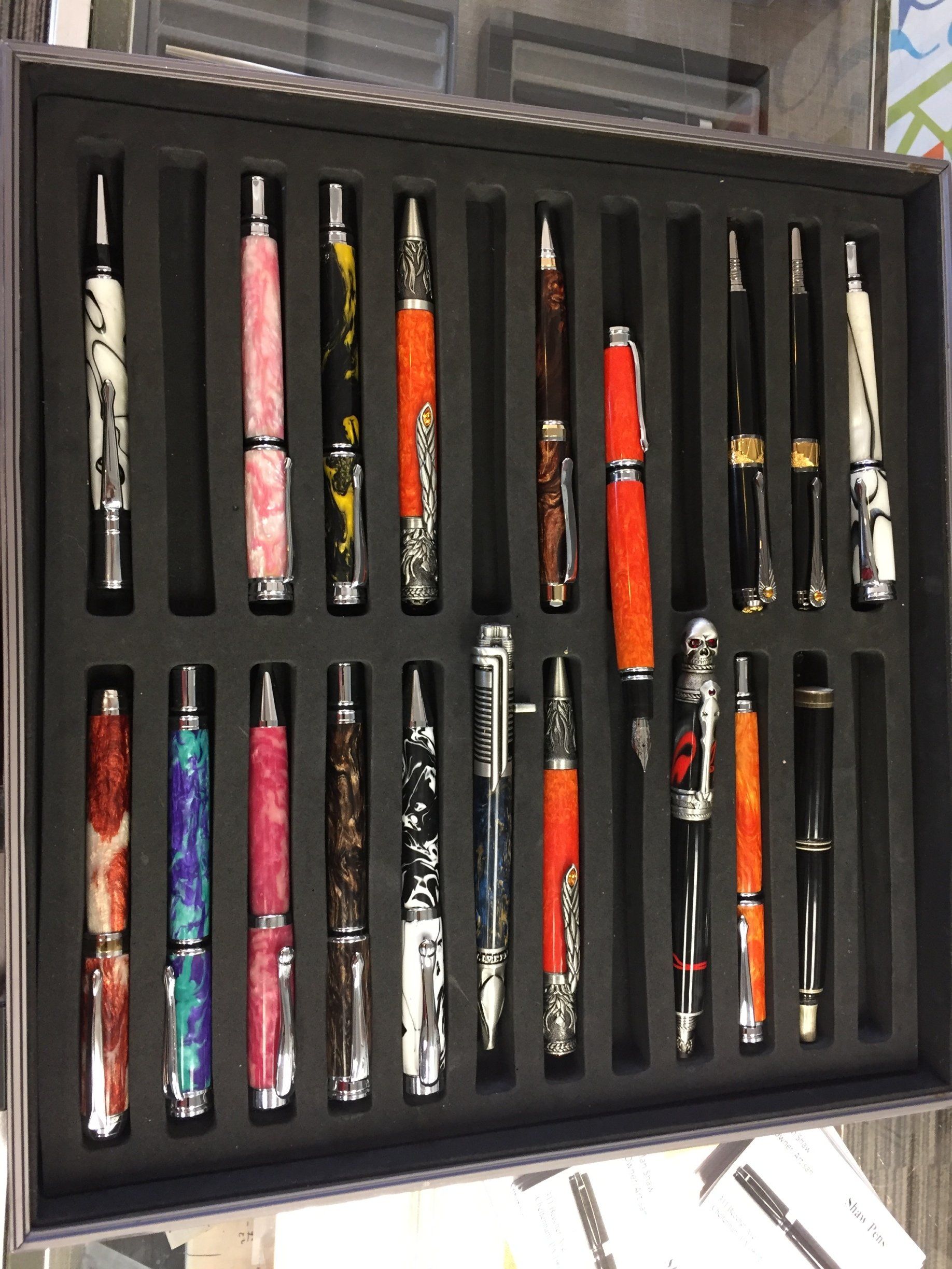 A box filled with many different colored pens