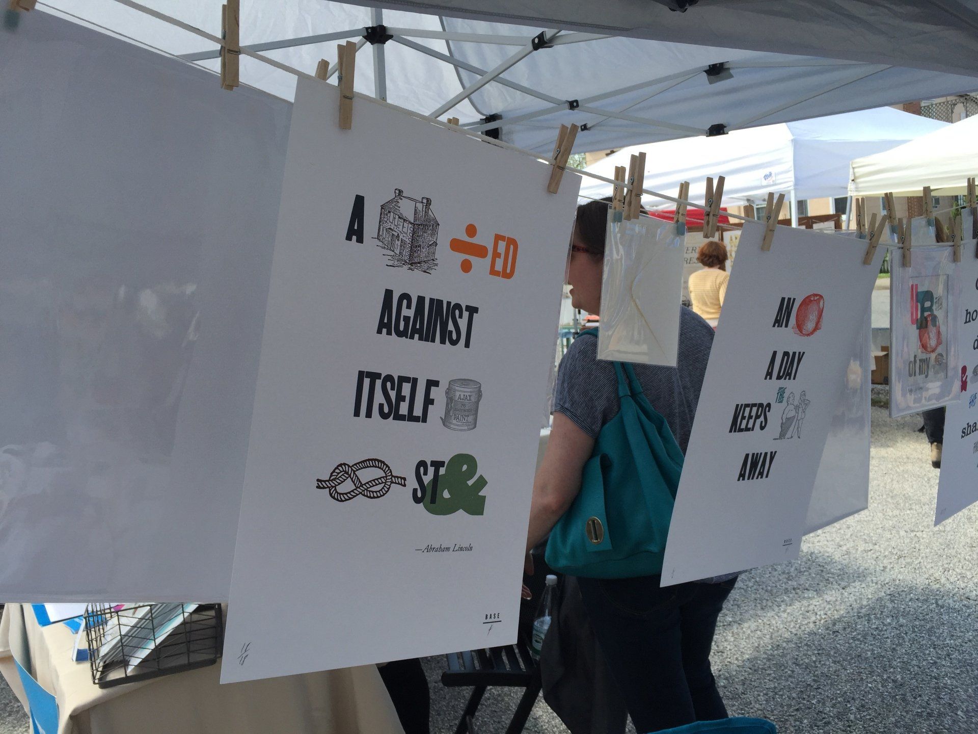 A sign that says a divided against itself hangs on a clothes line