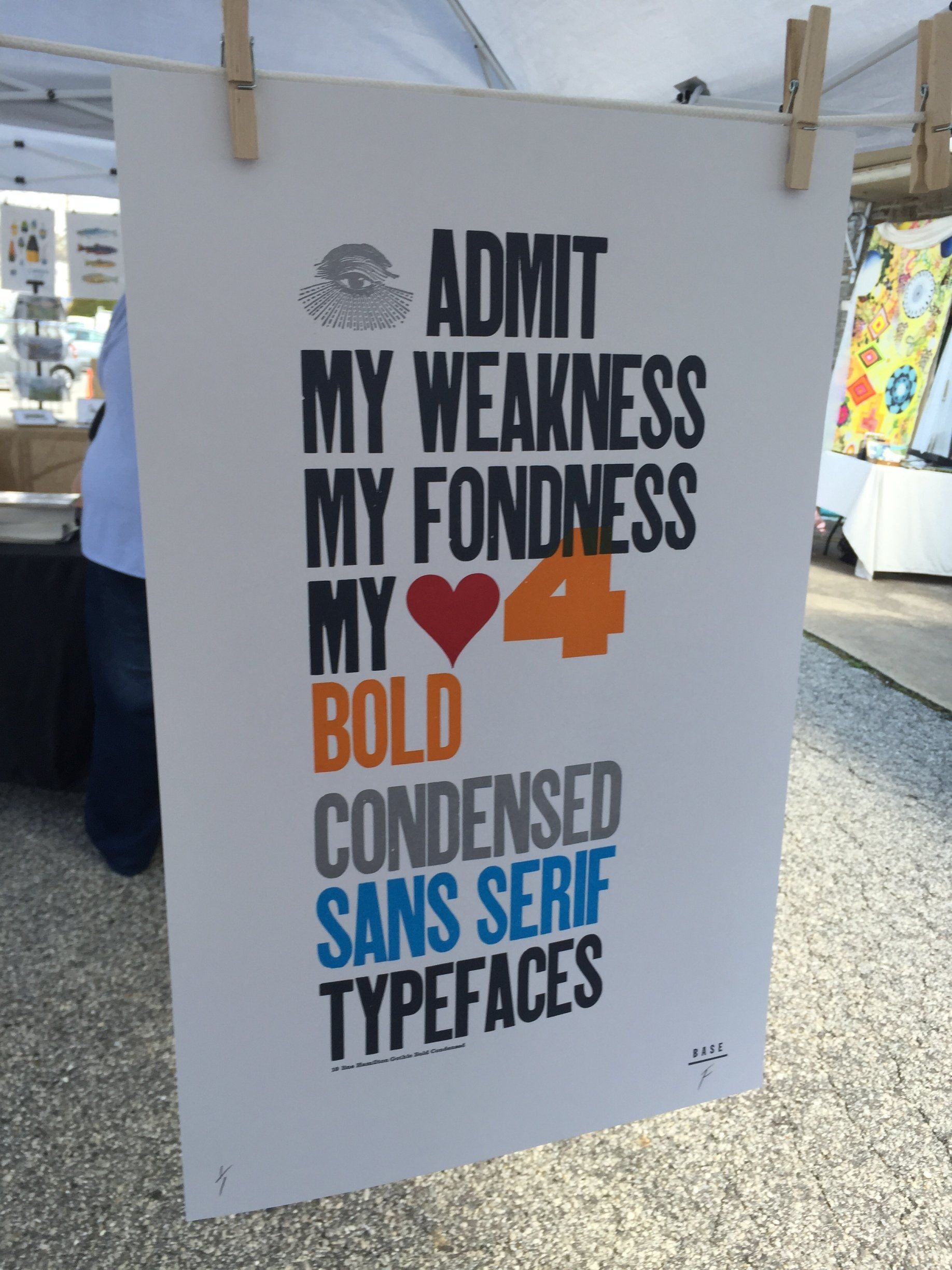 A sign that says admit my weakness my fondness my bold condensed sans serif typefaces