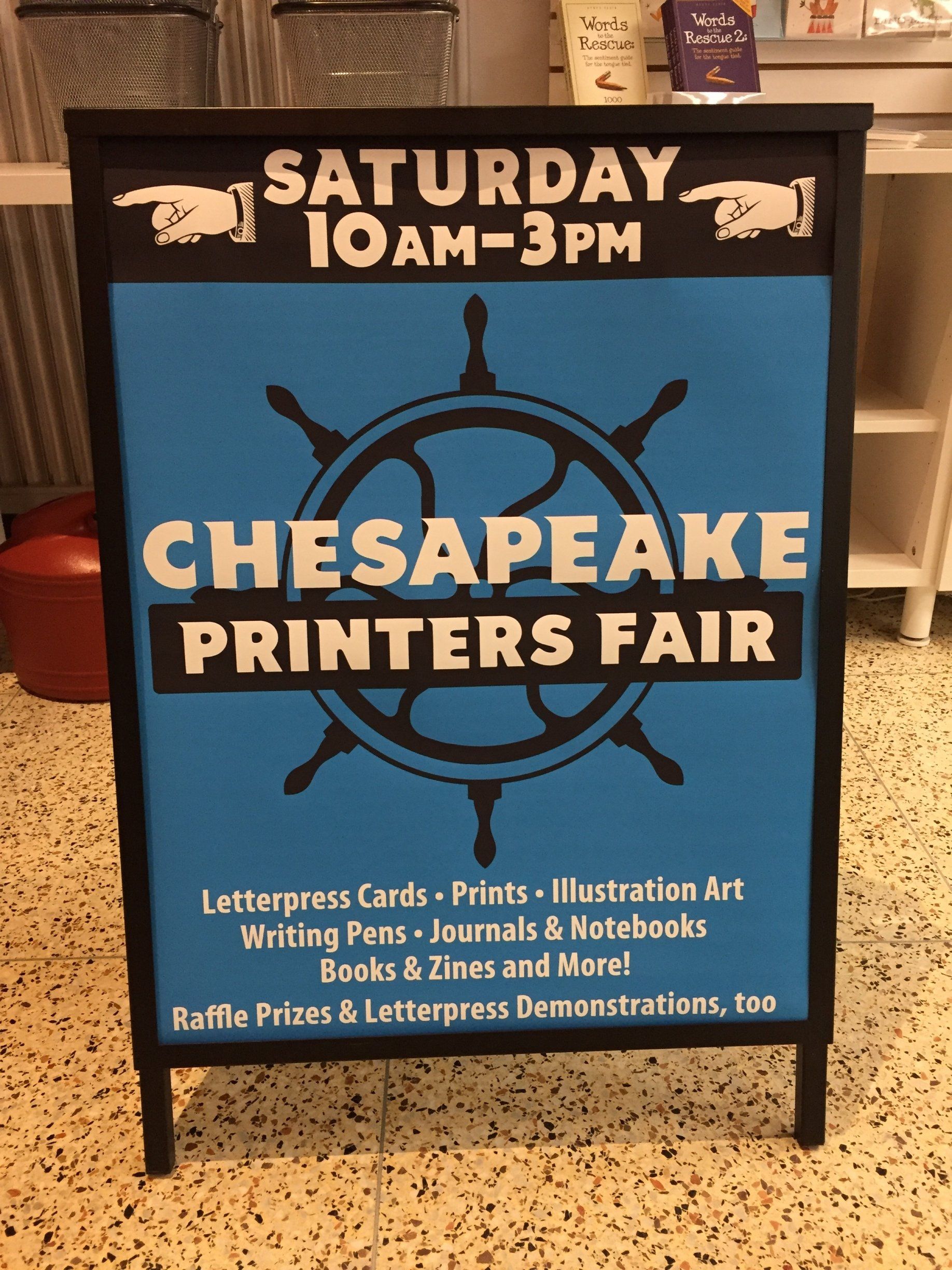 A blue sign advertises the chesapeake printers fair