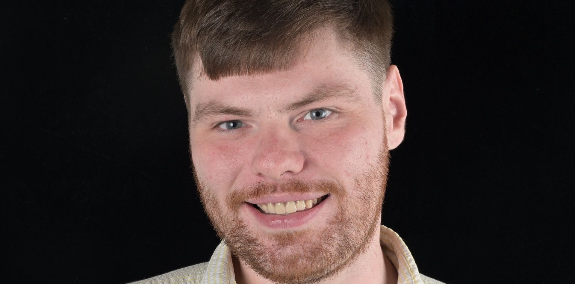 Close-up of human teeth, showing a row of upper teeth with visible gums and lips.