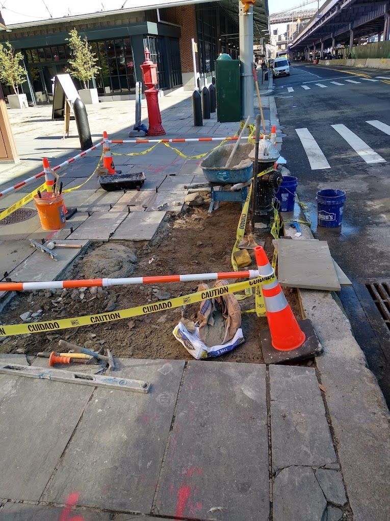 a construction site on the side of a city street .