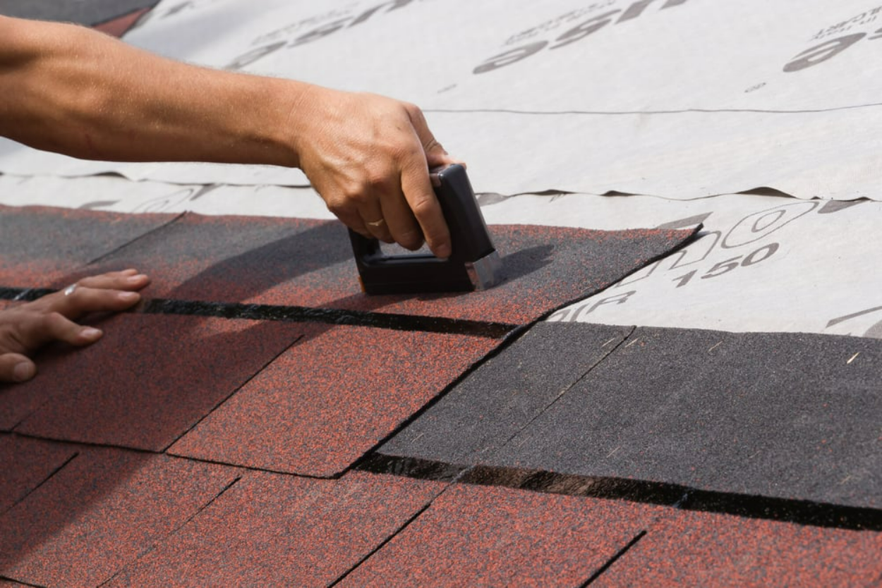 Man Stapling Shingles — Jamestown, NY — Nelson John C Vinyl Siding & Roofing Corp