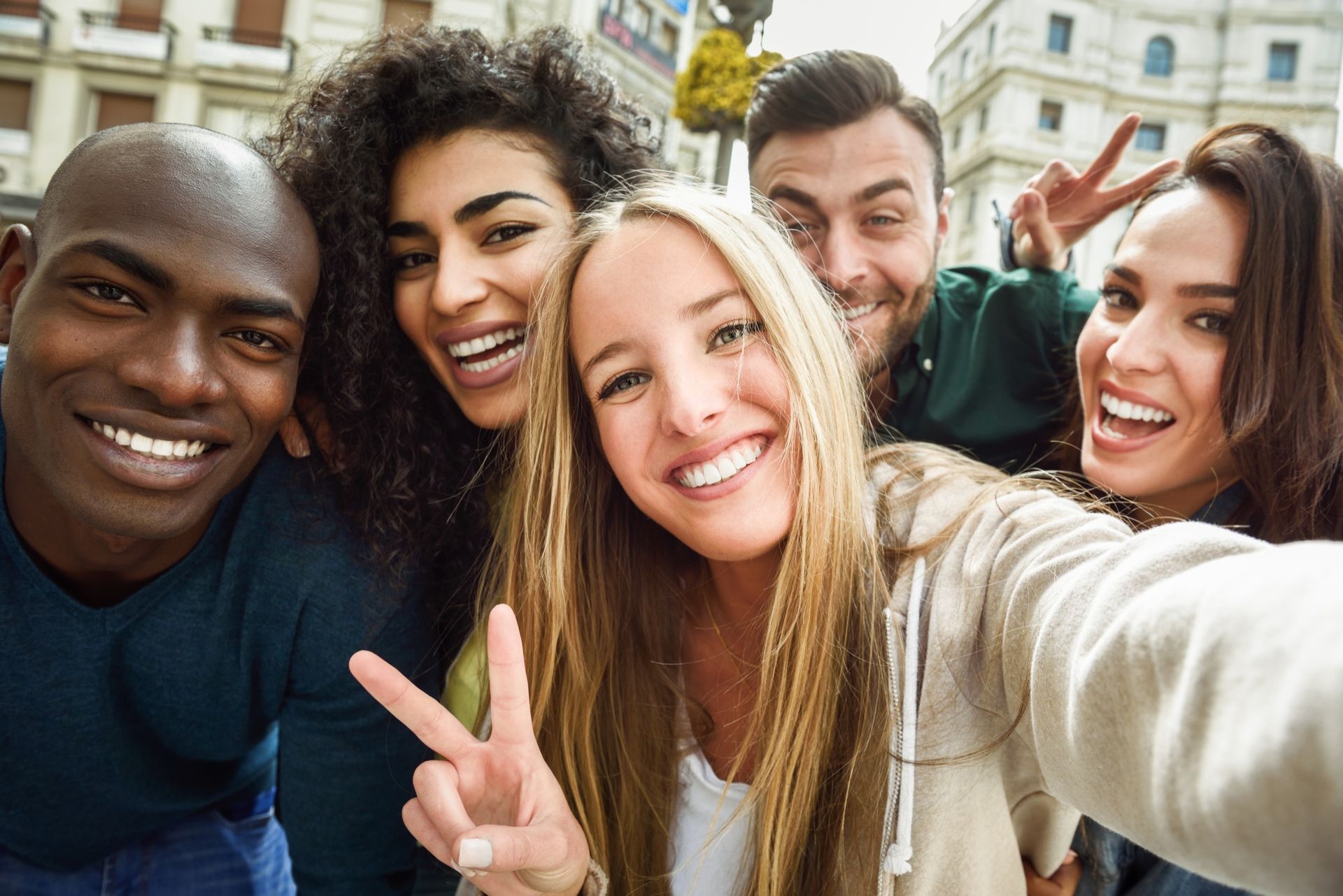 A group of young people are taking a selfie together.