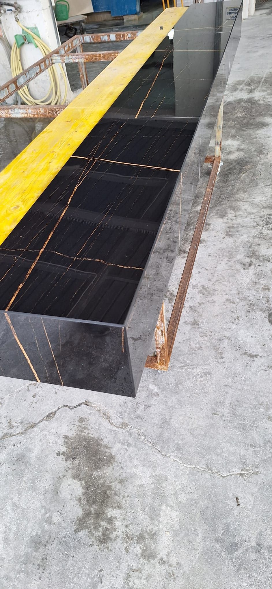 un pavimento di piastrelle nere con una linea gialla su di esso.