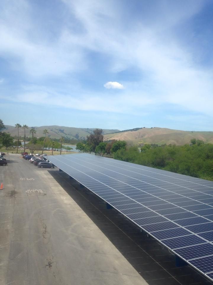A row of solar panels on top of a parking lot