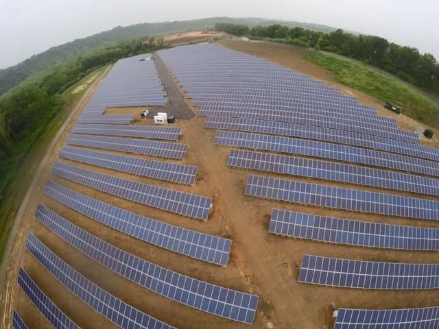 An aerial view of a large field of solar panels