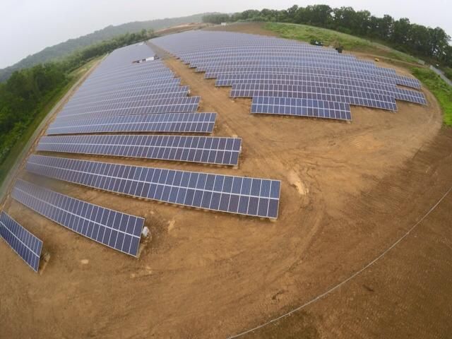 An aerial view of a large field of solar panels