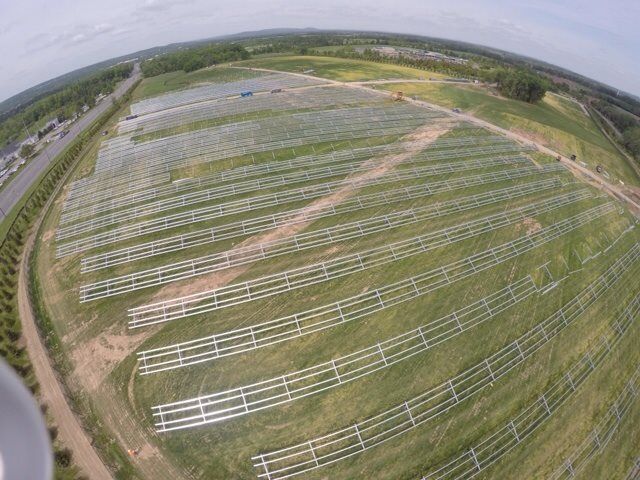 An aerial view of a large field of solar panels.