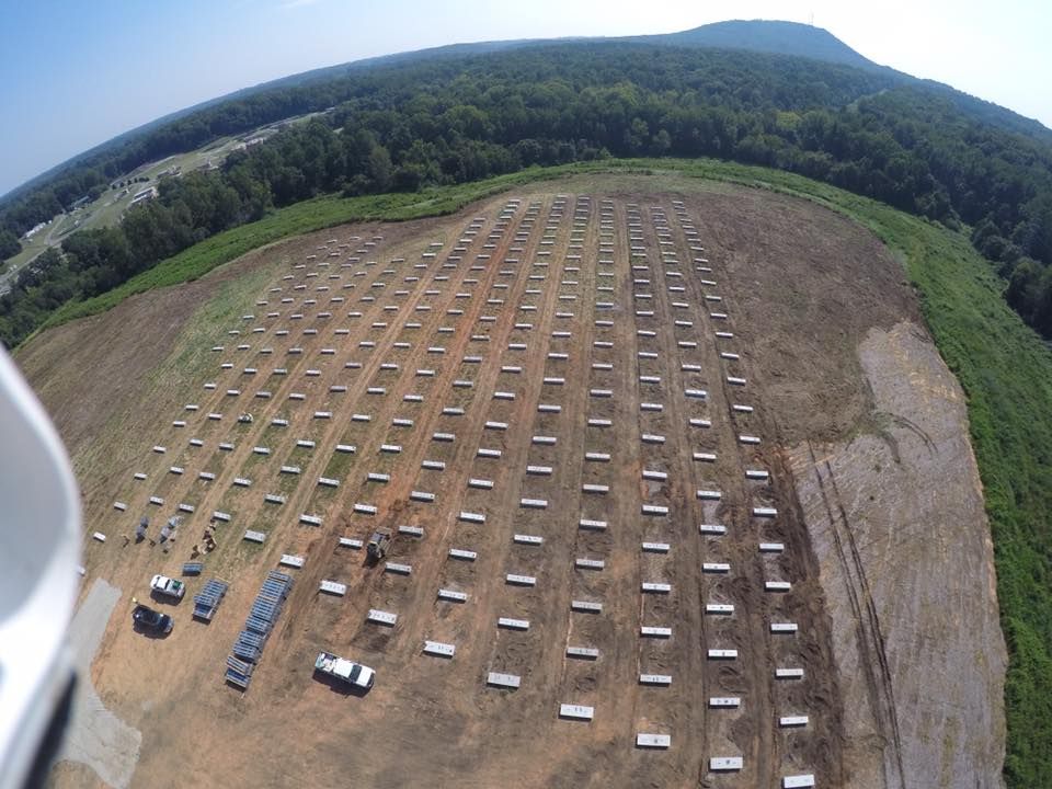An aerial view of a large field with a mountain in the background
