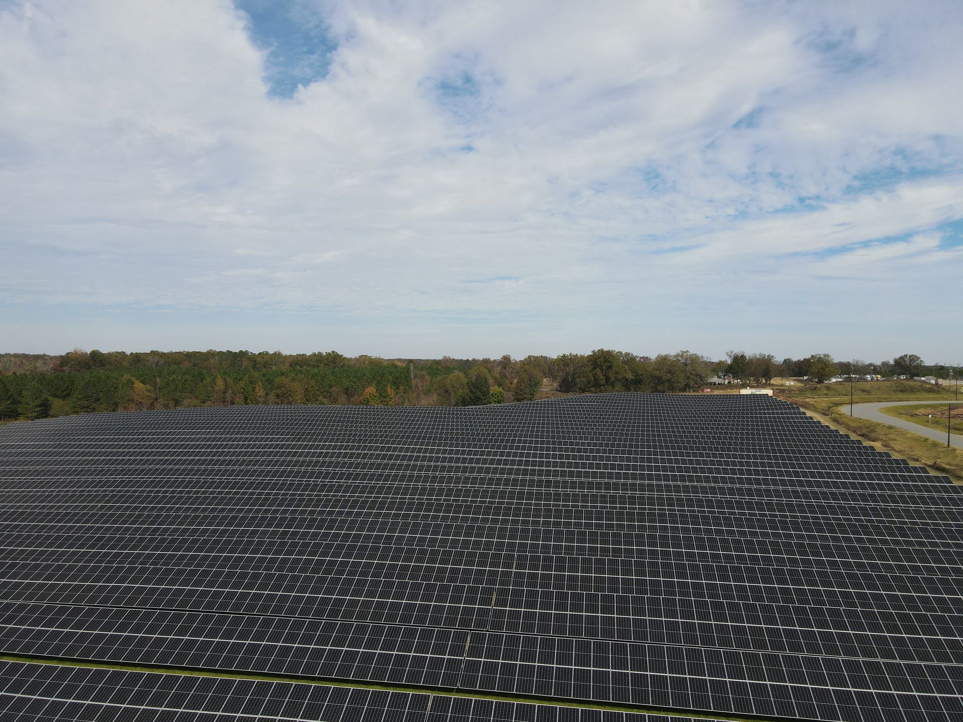 An aerial view of a large field of solar panels.