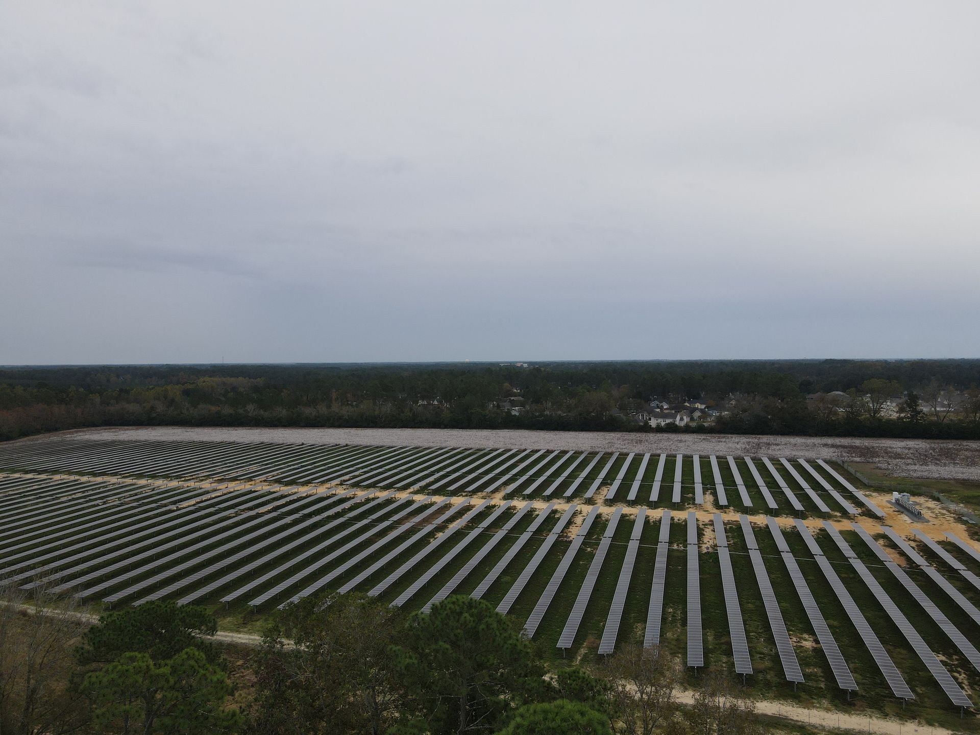 An aerial view of a large solar farm in the middle of a field.