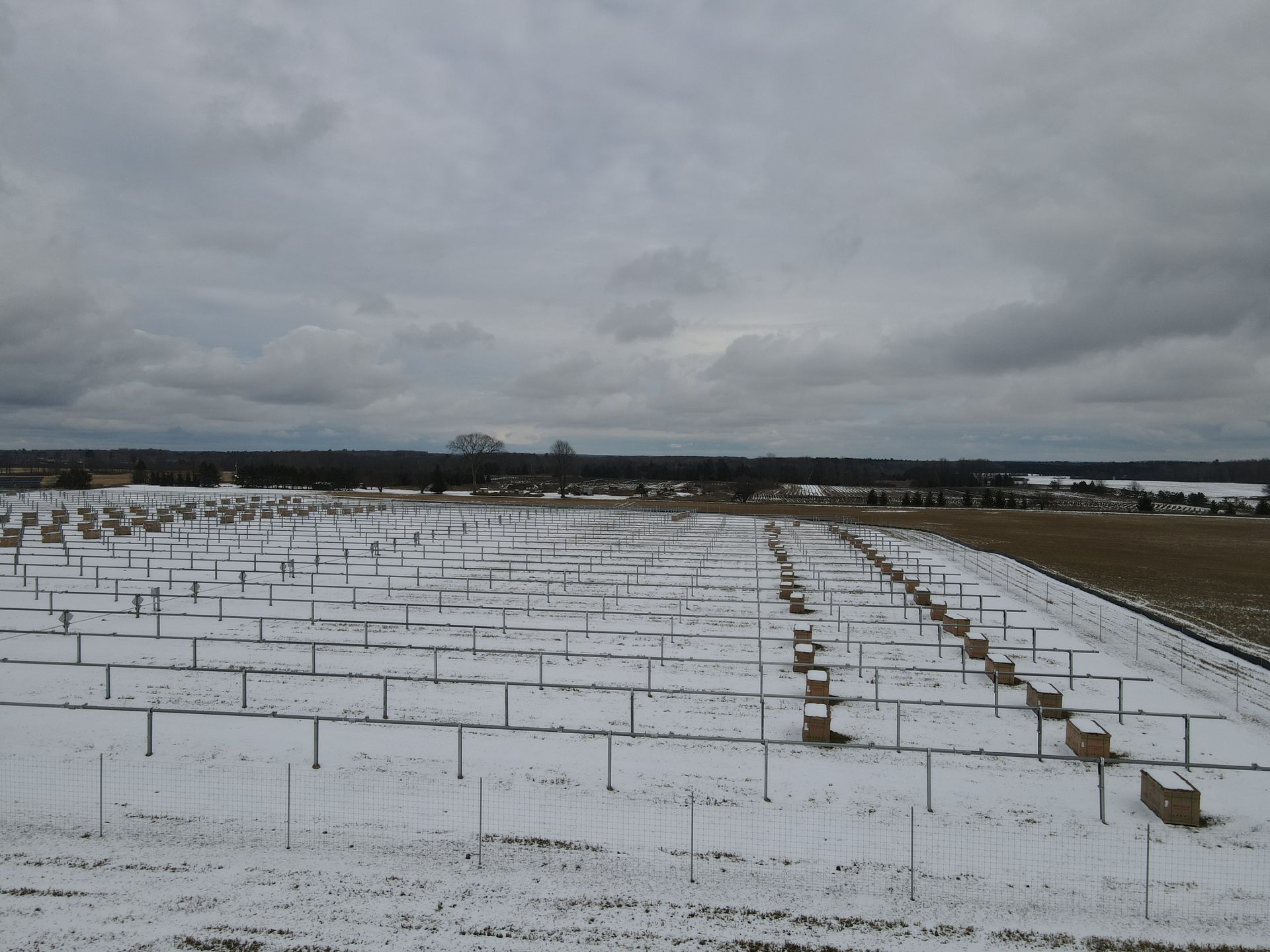 A snowy field with a lot of fences in it