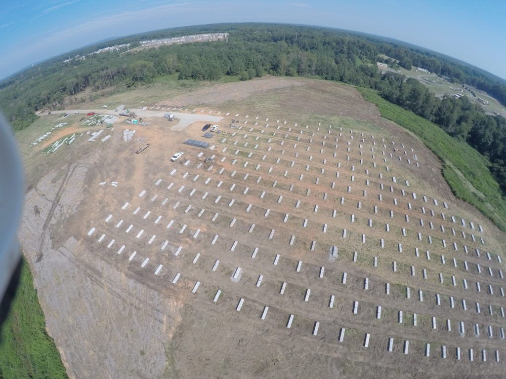 An aerial view of a large field of solar panels.