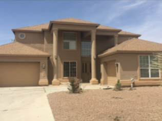 A large tan house with a brown roof