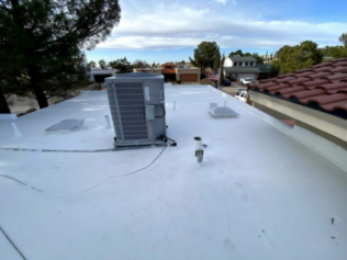 A white roof with an air conditioner on it