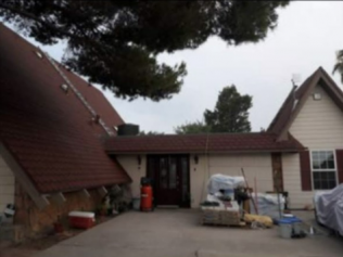 The front of a house with a red roof