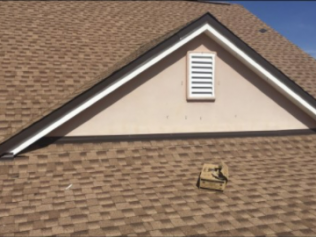 A roof with a triangle on it and a window