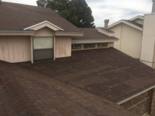 A house with a brown roof and a window