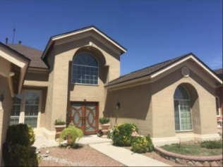 A large house with arched windows and a roof