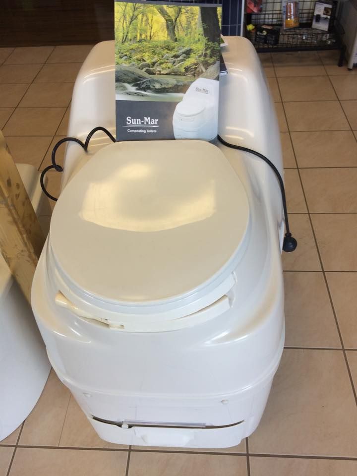 A White Toilet Is Sitting On A Tiled Floor In A Store — Evolution Solar Kingaroy in Kingaroy, QLD