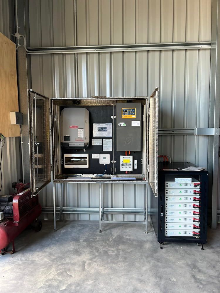 A Stainless Steel Cabinet Filled With Electrical Equipment In A Garage — Evolution Solar Kingaroy in Kingaroy, QLD