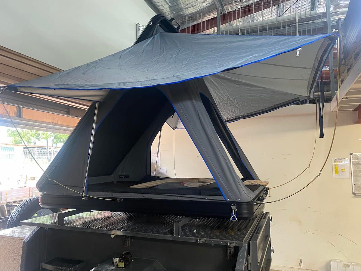 A Tent Is Sitting On Top Of A Trailer In A Garage — Evolution Solar Kingaroy in Kingaroy, QLD