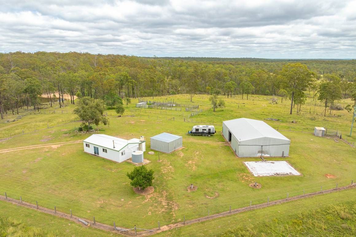 An aerial view of a farm with a lot of buildings and trees in the background — Evolution Solar Kingaroy in Durong, QLD