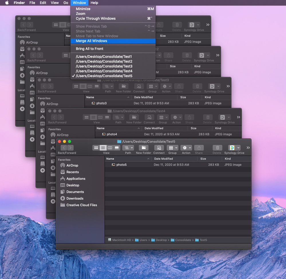 A stack of computer screens with a mountain in the background