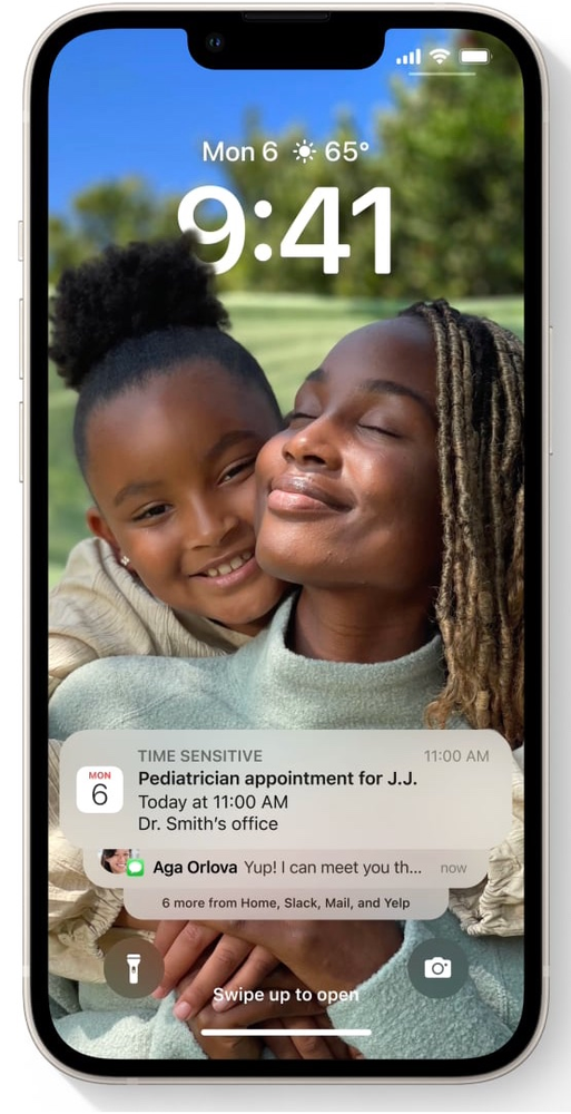 A phone with a picture of a woman and a child on the lock screen.